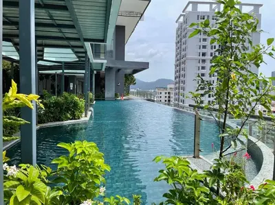 a swimming pool in the middle of a building at The Palm, 2BR Cityview by WStay @ Tropicana 218 Macalister in George Town