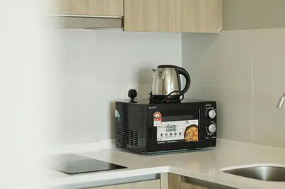 a microwave sitting on top of a kitchen counter at The Palm, 2BR Cityview by WStay @ Tropicana 218 Macalister in George Town