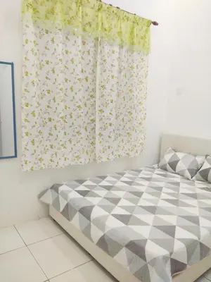 a bedroom with a bed and a window with a curtain at Tuah Homestay Musleem Only in Chemor