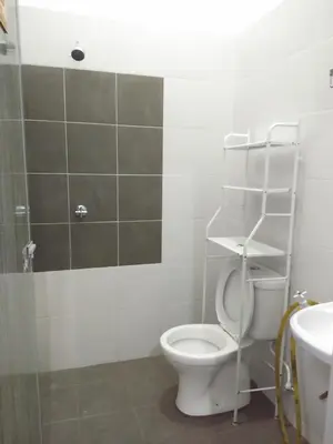 a bathroom with a toilet and a shower and a sink at Tuah Homestay Musleem Only in Chemor