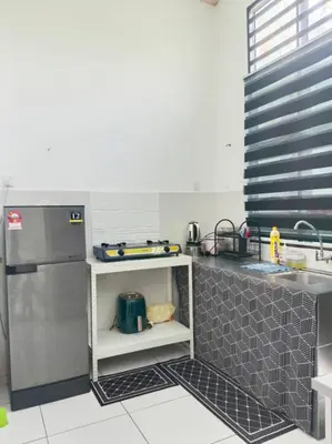 a kitchen with a stainless steel refrigerator and a sink at Tuah Homestay Musleem Only in Chemor