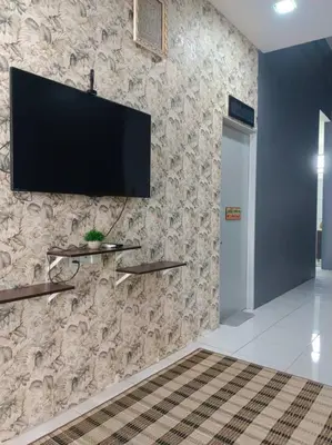 a wall with a television on a wall at Tuah Homestay Musleem Only in Chemor