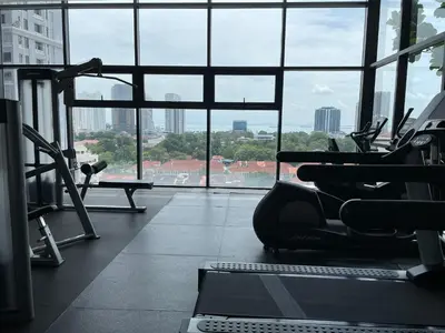 a gym with a view of a large window at The Aspen, 3BR Cityview by WStay @Tropicana 218 Macalister in George Town