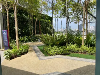 a garden with plants and trees and a walkway at The Aspen, 3BR Cityview by WStay @Tropicana 218 Macalister in George Town
