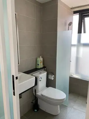 a bathroom with a white toilet and a sink at The Aspen, 3BR Cityview by WStay @Tropicana 218 Macalister in George Town