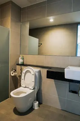 a bathroom with a toilet and a sink at The Pine, 3BR Seaview by WStay @ Tropicana 218 Macalister in George Town