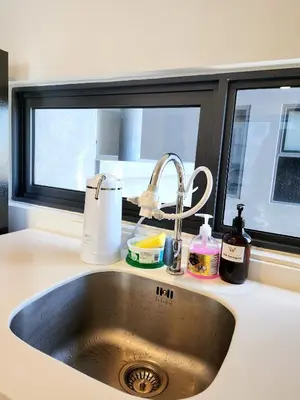 a kitchen counter with a sink and a window at The Pine, 3BR Seaview by WStay @ Tropicana 218 Macalister in George Town