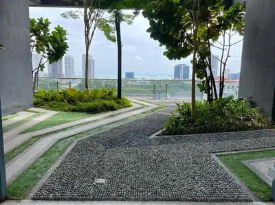 a walkway with trees and a view of the ocean at The Pine, 3BR Seaview by WStay @ Tropicana 218 Macalister in George Town
