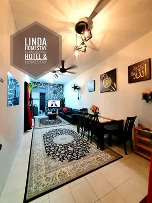 a living room with a table and a dining room at LH Alisha Homestay Wangsa Mewangi Gua Musang in Gua Musang