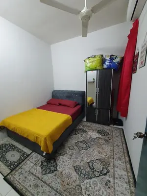 a bedroom with a bed in a room with a mirror at LH Alisha Homestay Wangsa Mewangi Gua Musang in Gua Musang
