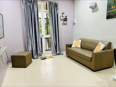 a living room with a couch and a window at Batu Feringgi Homestay in Batu Ferringhi