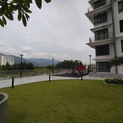 a park in front of a building with a grass field at 191 Cozy Casa Kayangan 3BR 6pax by Grab A Stay in Ipoh