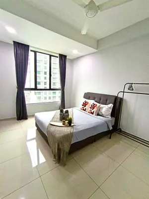 a bedroom with a bed with a table in it at 191 Cozy Casa Kayangan 3BR 6pax by Grab A Stay in Ipoh
