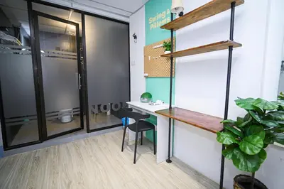 an office with a desk and a table in a room at Swing & Pillows @ Beach Street in George Town