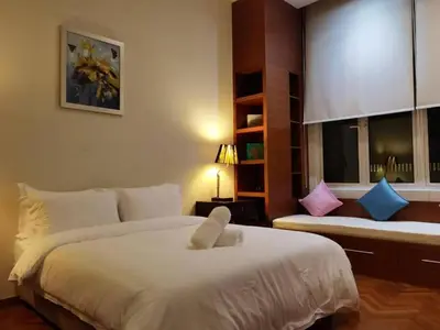 a bedroom with a large white bed and a window at WHITE HOUSE STRAITS QUAY MARINA LUXURY STAY GURNEY in Tanjong Tokong