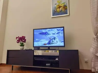a flat screen tv sitting on top of a entertainment center at WHITE HOUSE STRAITS QUAY MARINA LUXURY STAY GURNEY in Tanjong Tokong