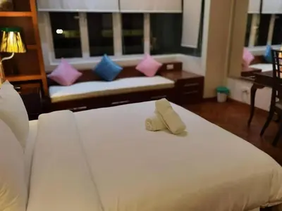 a hotel room with two beds with towels on them at WHITE HOUSE STRAITS QUAY MARINA LUXURY STAY GURNEY in Tanjong Tokong
