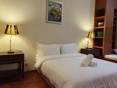 a bedroom with a bed with a teddy bear on it at WHITE HOUSE STRAITS QUAY MARINA LUXURY STAY GURNEY in Tanjong Tokong