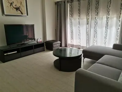 a living room with a couch and a television at By The Sea Batu Ferringhi Beach Front, Seaview And Pool Front in Batu Ferringhi