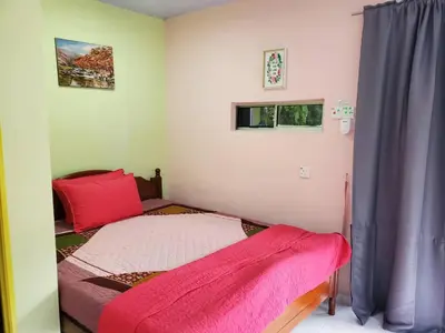 a small bedroom with a bed and a window at Inap Desa 3 in Kampong Siput