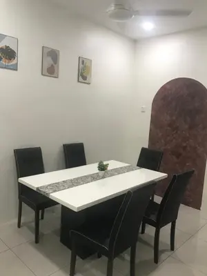 a dining room with a white table and chairs at Koolest homestays Meru in Ipoh