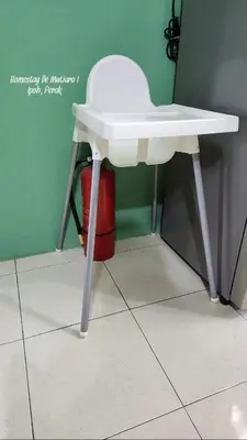 a white stool sitting on the floor next to a table at Homestay De Mutiara Tasek Ipoh in Ipoh
