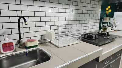 a kitchen counter with a sink and a sink at Homestay De Mutiara Tasek Ipoh in Ipoh