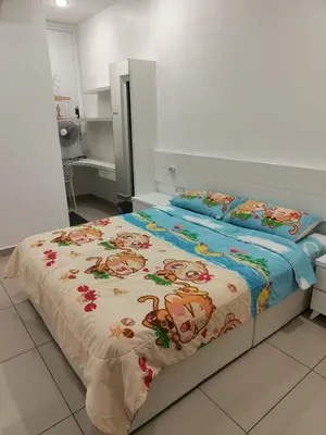 a bedroom with a bed with a blanket with monkeys on it at Prestij 3 Homestay, Balik Pulau in Balik Pulau