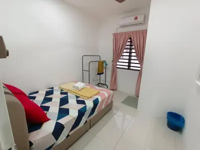 a small bedroom with a bed and a window at D’sayang homestay klebang ipoh in Ipoh