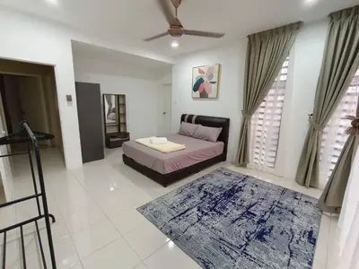 a living room with a bed and a rug at D’sayang homestay klebang ipoh in Ipoh
