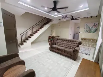 a living room with a couch and a staircase at D’sayang homestay klebang ipoh in Ipoh