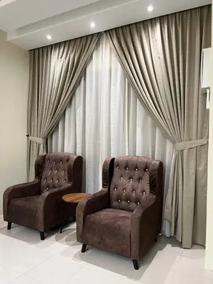 two chairs and a table in front of a window at D’sayang homestay klebang ipoh in Ipoh