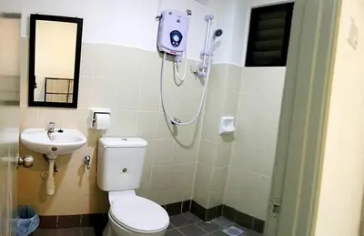 a bathroom with a shower and a toilet and a sink at “Alan Homestay” Pangkor Lot 10 in Kampong Sungai Udang