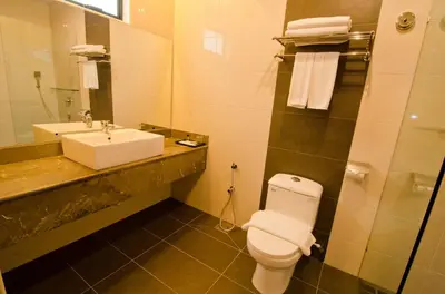 a bathroom with a white toilet and a sink at MyDream Guest House in Ipoh