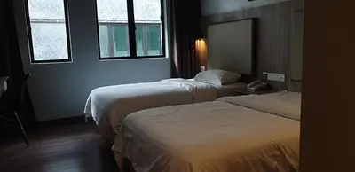 a hotel room with two beds and two windows at MyDream Guest House in Ipoh