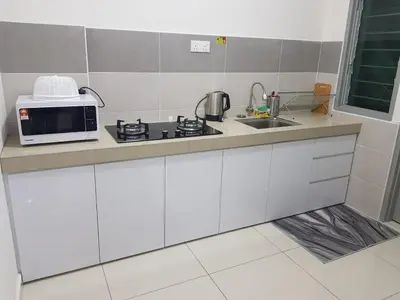 a white kitchen with a microwave and a sink at D' Homestay Meru Ipoh - Free WiFi in Ipoh