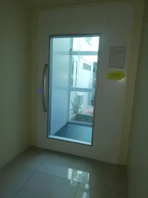 a glass window in a room with a door at Hotel Damai in Parit Buntar