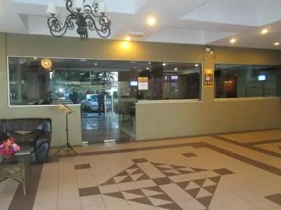 a lobby of a building with a chandelier at Hotel Damai in Parit Buntar