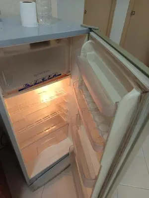 an empty refrigerator with its door open in a kitchen at My Getaway Home @Marina Cove in Lumut