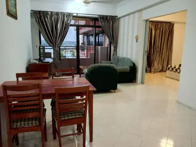 a living room with a wooden table and chairs at My Getaway Home @Marina Cove in Lumut