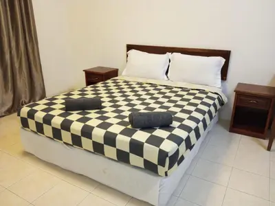 a bedroom with a black and white checkered bed at My Getaway Home @Marina Cove in Lumut
