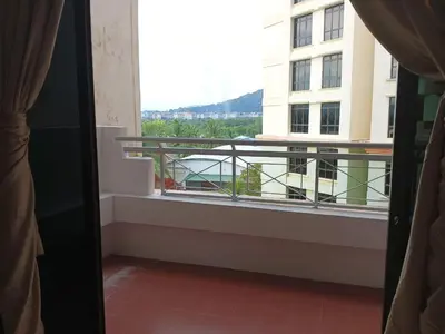 a balcony with a view of a building at My Getaway Home @Marina Cove in Lumut