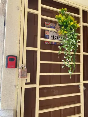 a wooden door with a flower pot on it at LH Homestay Bandar Utama Gua Musang in Gua Musang