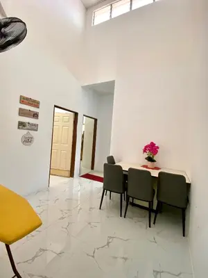 a dining room with a table and chairs at LH Homestay Bandar Utama Gua Musang in Gua Musang