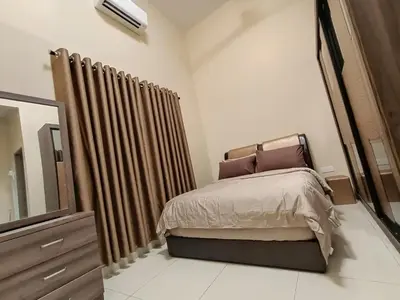 a bedroom with a bed and a dresser and a mirror at Rumah Hana Sungai Besar - Mslim0nly in Sungai Besar