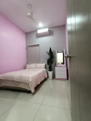 a bedroom with a bed and a pink wall at Rumah Hana Sungai Besar - Mslim0nly in Sungai Besar