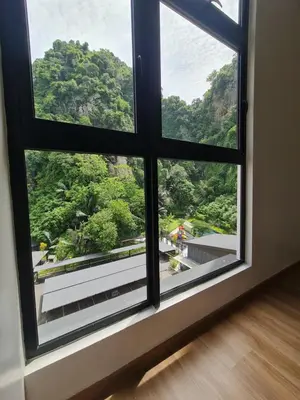 a window with a view of a mountain at The Cove Hillside Condominium in Ipoh