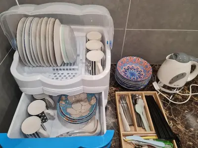 a plastic container filled with dishes and other kitchen utensils at The Cove Hillside Condominium in Ipoh