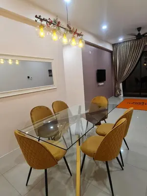 a dining room with a glass table and chairs at The Cove Hillside Condominium in Ipoh