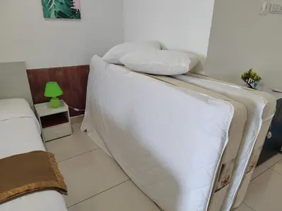 a bedroom with two beds and a green lamp at Exclusive Studio/ 1~4pax/ Gurney/ Mansion One in George Town